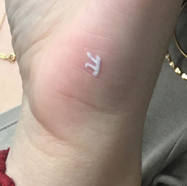Small white ink pi tattoo by Alex Ponce