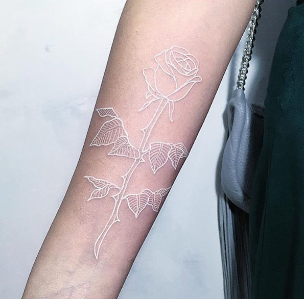 White ink rose tattoo on forearm by Mirko Sata