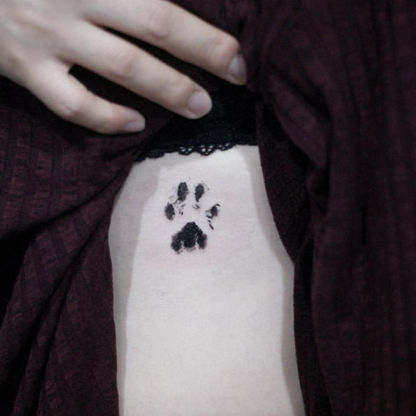 Blackwork paw print tattoo by Doy