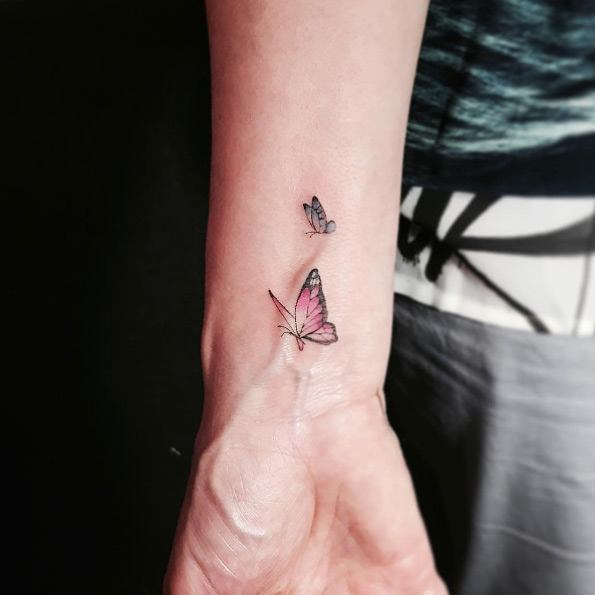 Small butterflies on wrist by Masa Tattooer