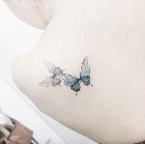 Playful butterfly tattoos on back shoulder by Tattooist Flower