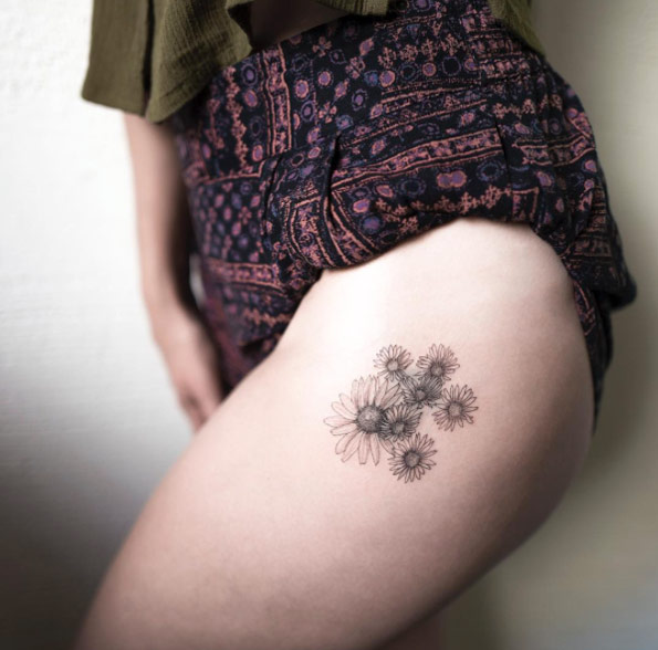 Tiny chamomile flowers on thigh by Hongdam