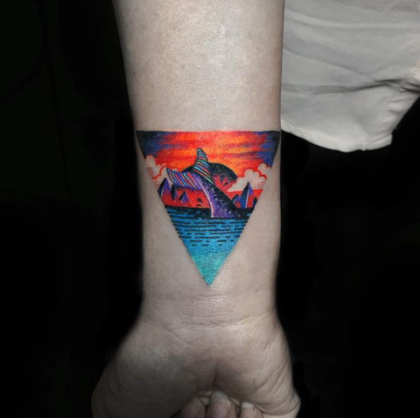 Colorful triangular glyph tattoo by Nadya Natassya