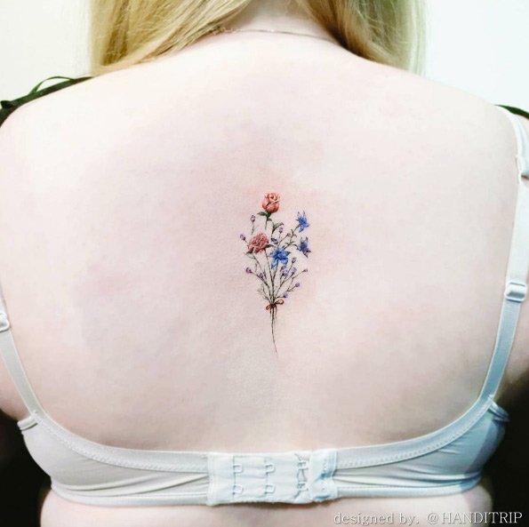 Dainty flower bouquet tattoo on back by Handitrip