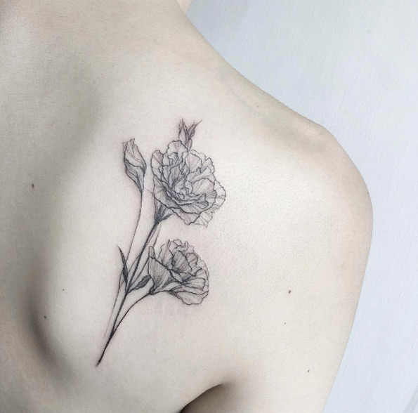 Delicate black and grey ink floral tattoo on back shoulder by Tattooist Flower