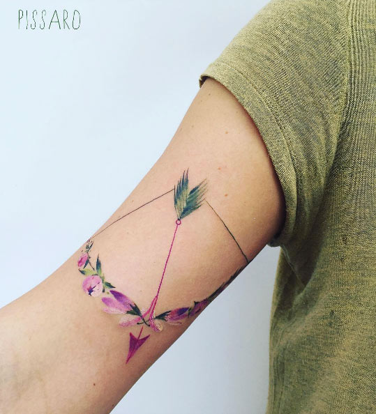 Floral bow and arrow tattoo by Pis Saro