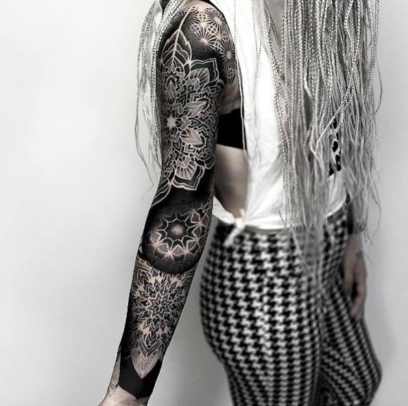 Dynamic geometric sleeve tattoo by Darkside Tattoo