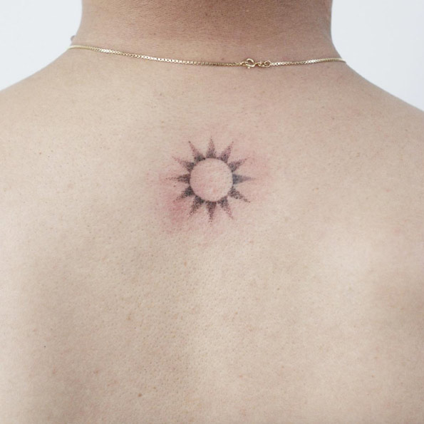 Hand poked sun tattoo by Tattooist Doy