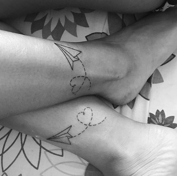 Matching paper plane tattoos via Aurora De Luca