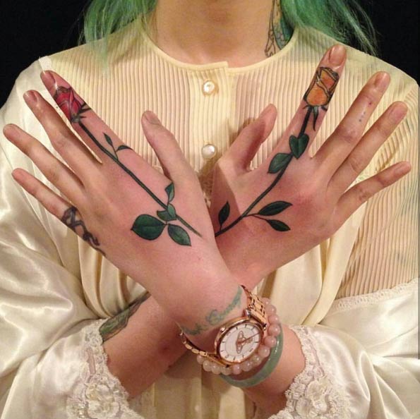 Rose tattoos on hands and fingers by Nalla Smith