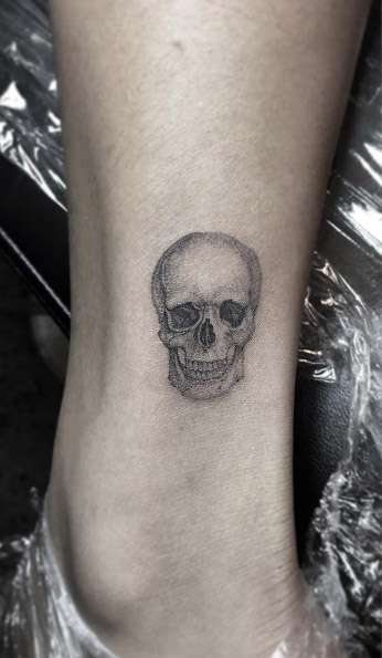 Skull ankle tattoo by Zeke