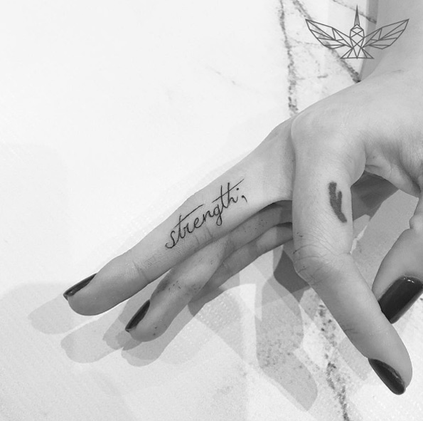 'Strength' finger tat by Cholo