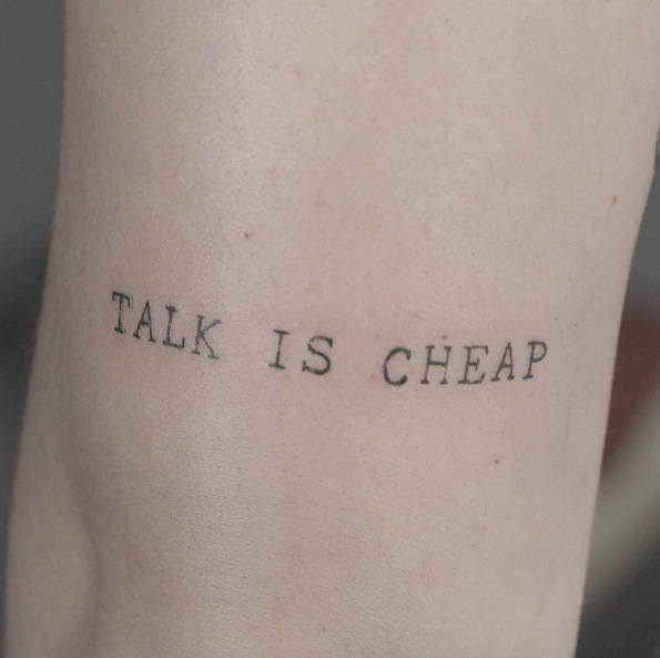 'Talk is cheap' typewriter font tattoo by Lindsay April
