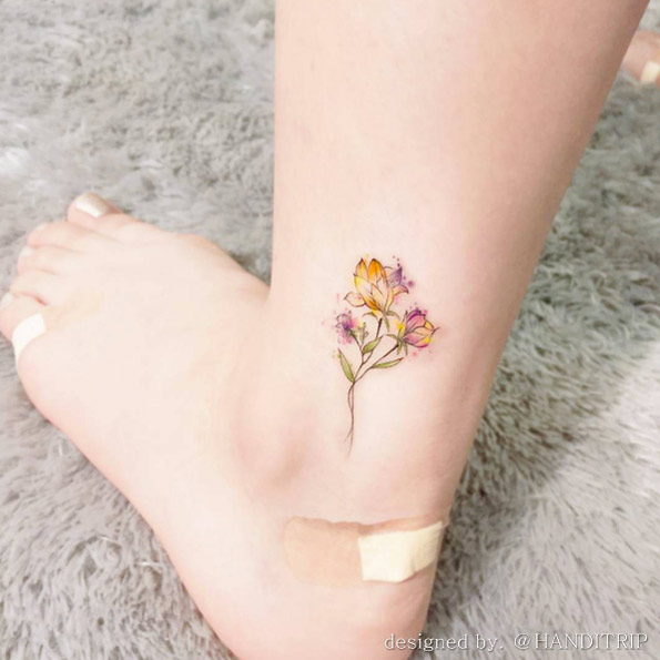 Possibly the best mini watercolor floral tattoo we've seen. By Handitrip