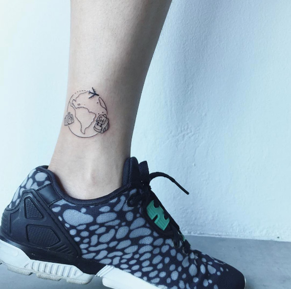 Travel tattoo on ankle by Raice Wong