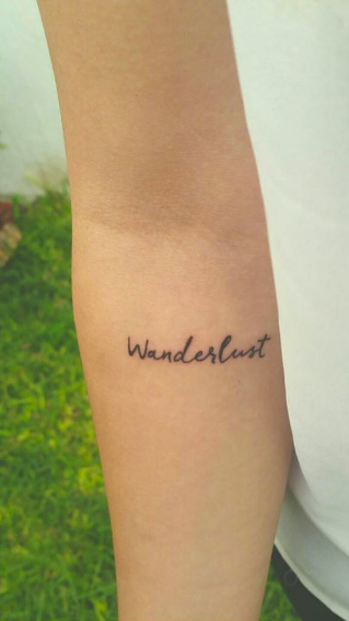 'Wanderlust' tattoo on forearm via Pau Soto