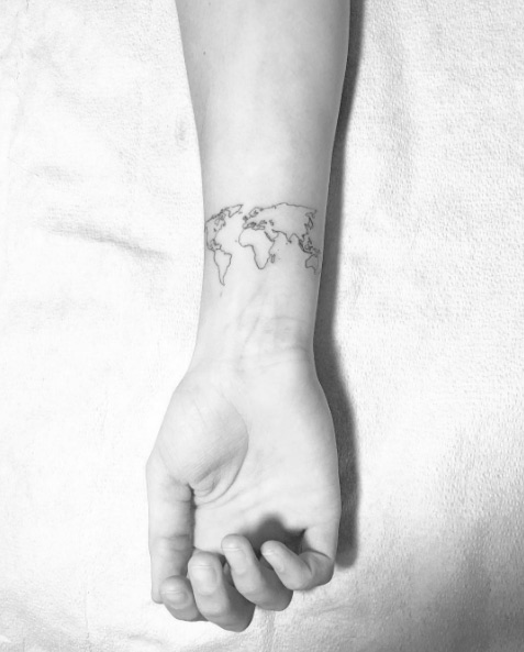 World map wrist tattoo by Bodies Need Rest