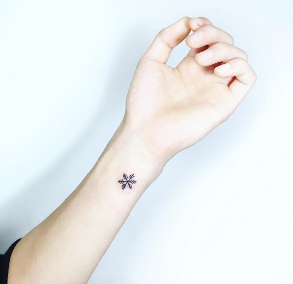 Minimalistic snowflake on wrist by Tattooist IDA