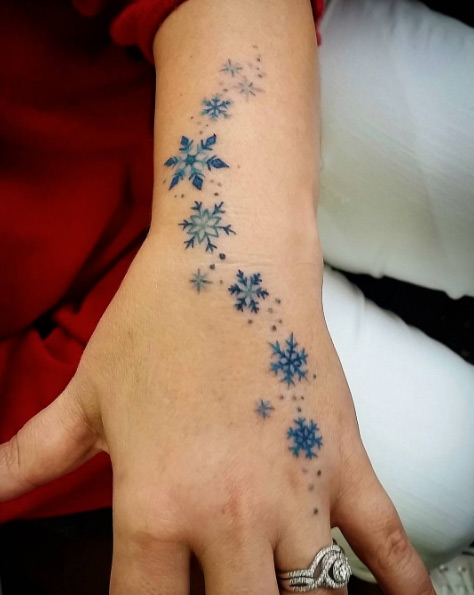 Falling blue snowflakes by Laura Jade