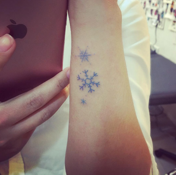 Blue ink snowflakes on wrist by Celine H