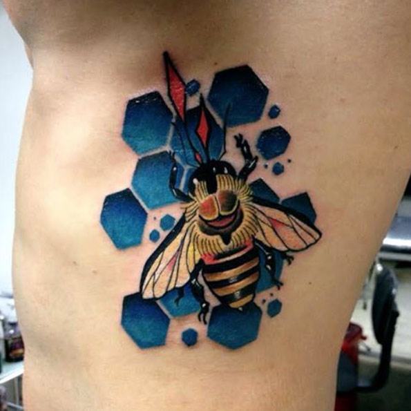 Bee on blue honeycomb tattoo by Daniel Rozo