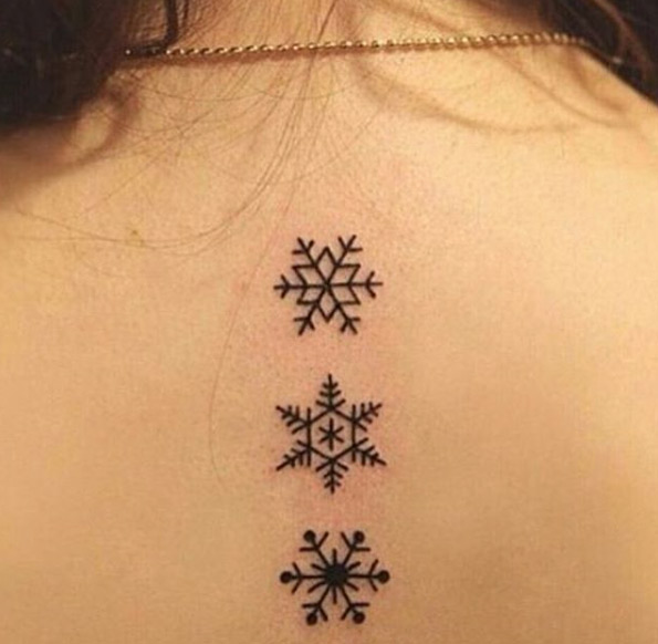Various blackwork snowflake tattoos by Negra Tattoo