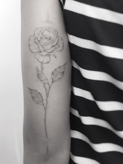 Delicate rose tattoo by Jakub Nowicz