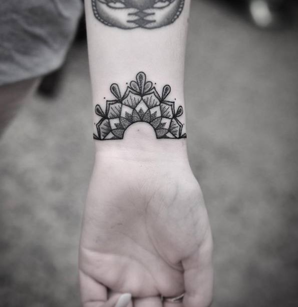 Half mandala tattoo on wrist by Chris Jones