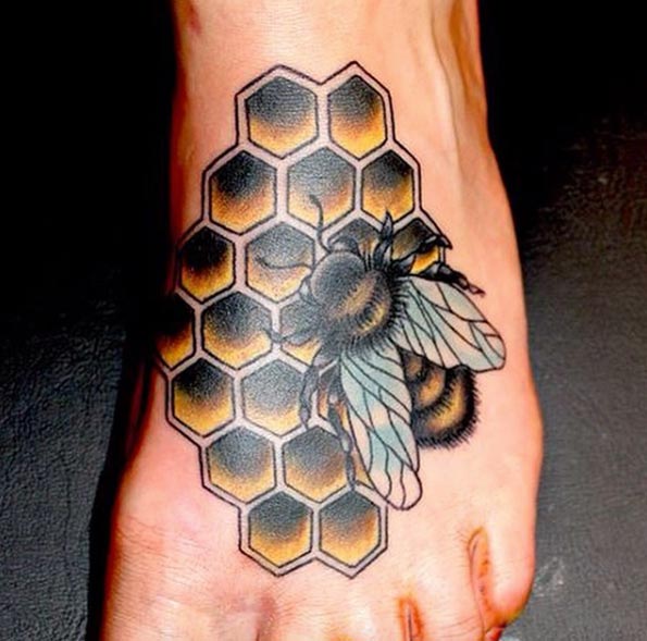 Honeycomb and bee on foot by E Lisa Betha