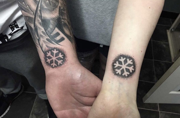 Matching snowflake tattoos by Mark James Steppie