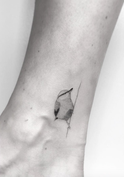 Micro songbird tattoo by Jakub Nowicz