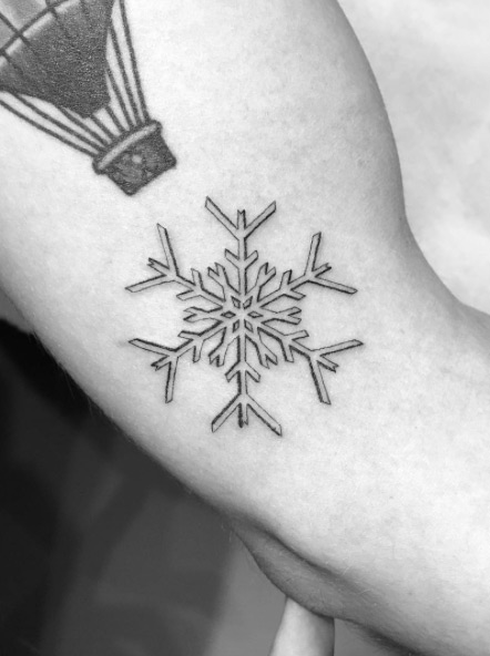 Simple snowflake tattoo by Daniel Winter