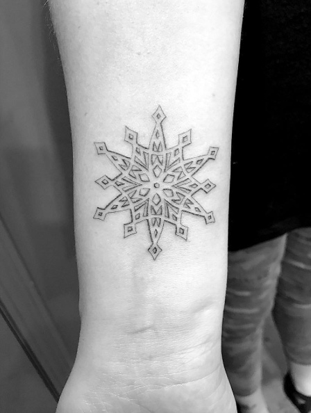 Single needle snowflake tattoo by Daniel Winter