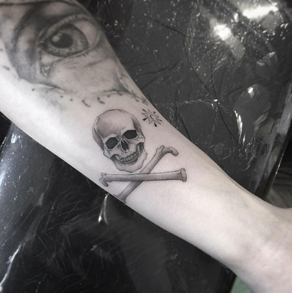 Skull and bones tattoo by Isaiah Negrete
