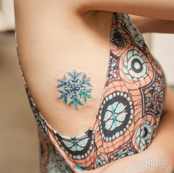 Snowflake tattoo on rib cage by Tattooist River