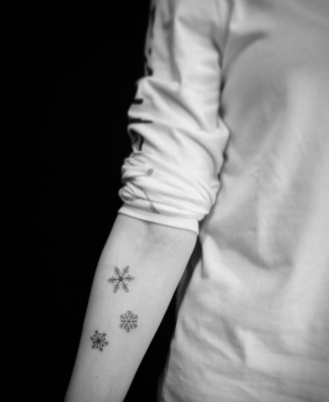 Tiny snowflakes on forearm by Lilo