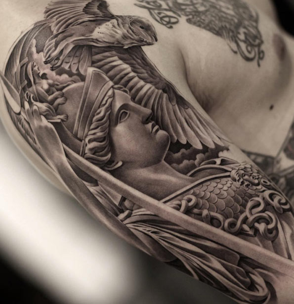 Black and grey ink statue tattoo by Jun Cha