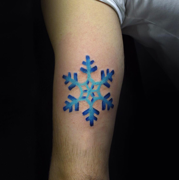 Stunning blue snowflake tattoo by Fatih Odabas