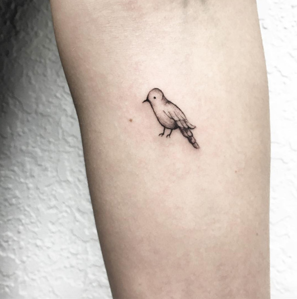 Tiny bird tattoo by Luiza Oliveira