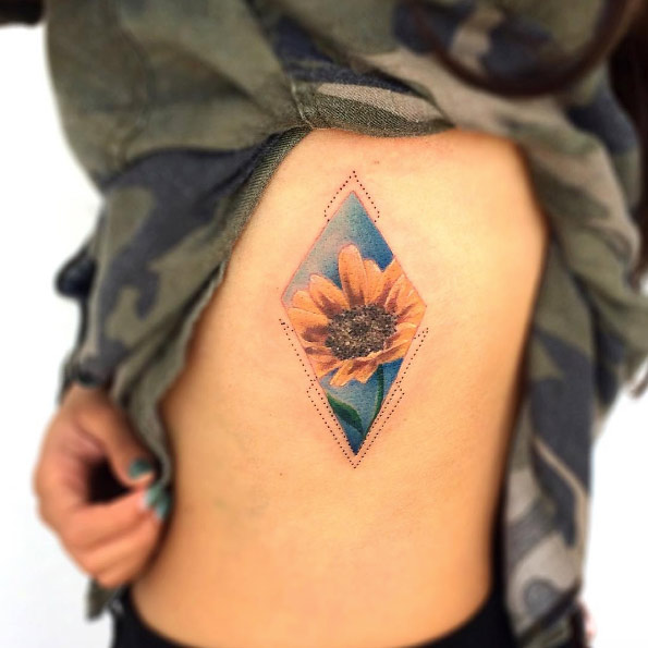Watercolor sunflower tattoo on rib cage by Bryan Gutierrez