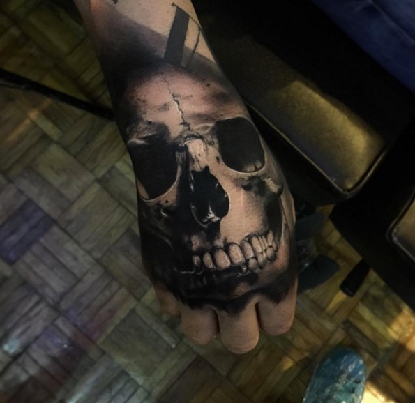 Heavy blackwork skull on hand by Alex Bruz