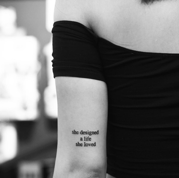 'She designed a life she loved' quote tattoo by Evan Tattoo