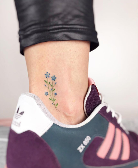 Tiny floral ankle tattoo by Jakub Nowicz 