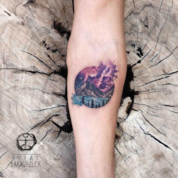 Cosmic-colored landscape tattoo by Koray Karagozler