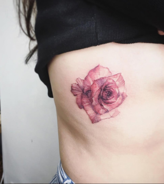 Watercolor rose on rib cage by Tattooist Flower