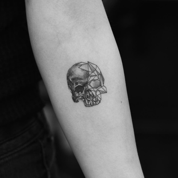 Small geometric skull tattoo by Evan Tattoo