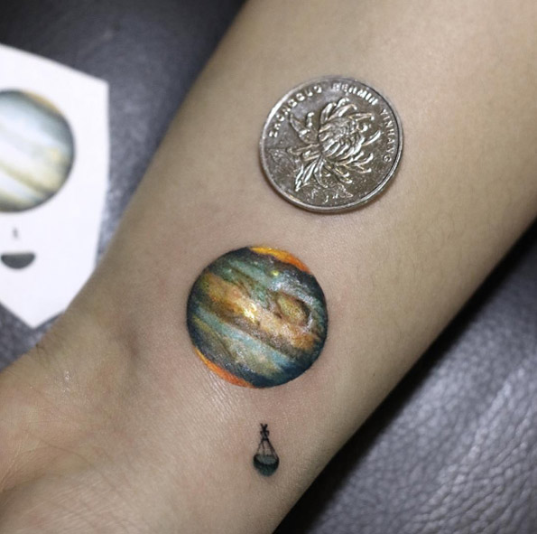 Mind-boggling planet tattoo by Victoria Lee
