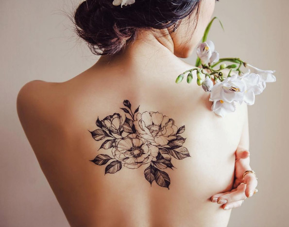 Blackwork floral piece on back by Zihee