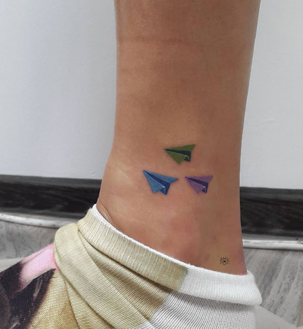 Paper airplanes on airplane by Shel Tattoo