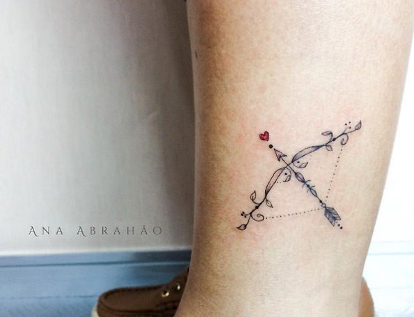 Decorative bow and arrow tattoo by Ana Abrahao